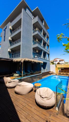 a hotel with a swimming pool and a building at Hotel Piramida in Ksamil