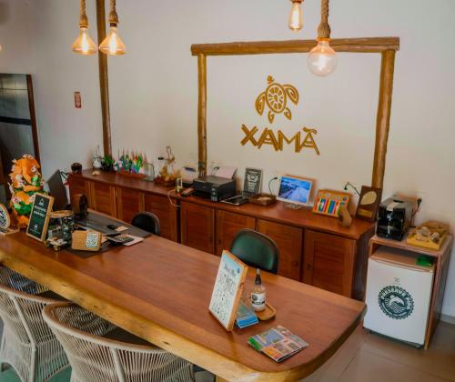 a court room with a wooden table and chairs at Xamã Senses - Hotel Pousada in Pipa