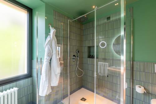 a bathroom with a shower with a glass door at Casa Du Lac, by R Collection Hotels in Varenna