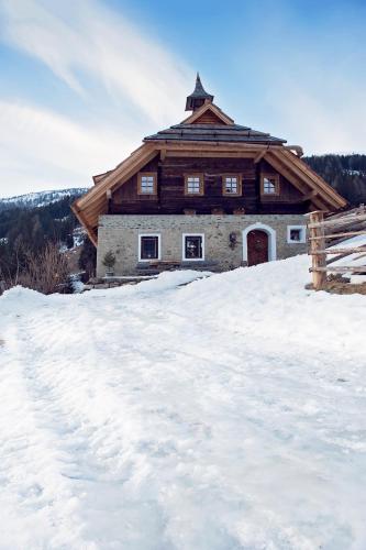a house on top of a pile of snow at Sandrisser-Hütte in Innerkrems