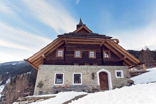 a house on top of a snow covered mountain at Sandrisser-Hütte in Innerkrems