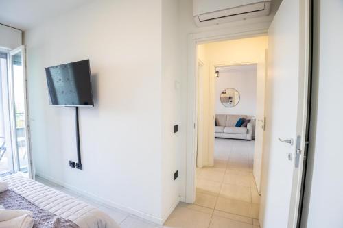 a living room with a flat screen tv on a wall at Le Ninfee in Zola Predosa