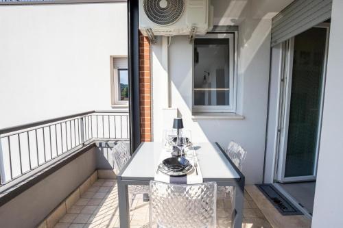 a balcony with a table and chairs on it at Le Ninfee in Zola Predosa