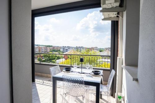 a balcony with a table and chairs and a view at Le Ninfee in Zola Predosa