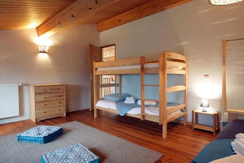 a bedroom with two bunk beds in a house at Gite rural de Bergnes à l'ombre des grands pins in Campagne-sur-Aude