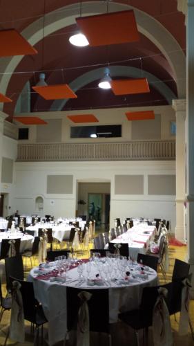 a large banquet hall with white tables and chairs at Le Prieuré in Saint-Dalmas-de-Tende