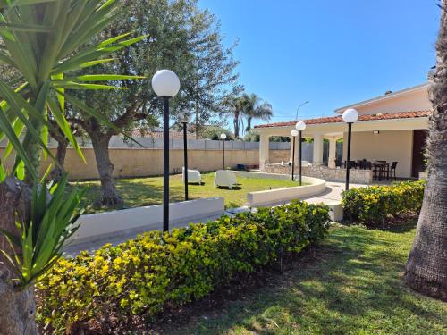 a park with chairs and trees and a building at Villa Carmela Arenella in Arenella