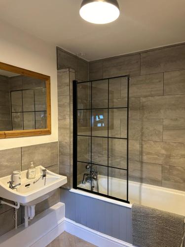 a bathroom with a sink and a bath tub at St Cuthbert's Keep in Bedford