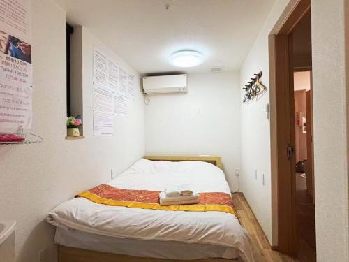 Postel nebo postele na pokoji v ubytování 花乃郷 池袋b