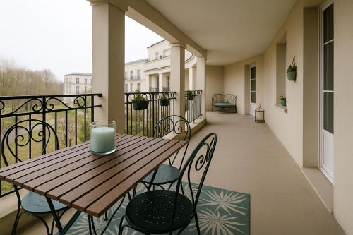 a wooden table on a balcony with a candle on it at Magic Disney Terrasse - 2 ch - parking gratuit - 5 min parc in Serris