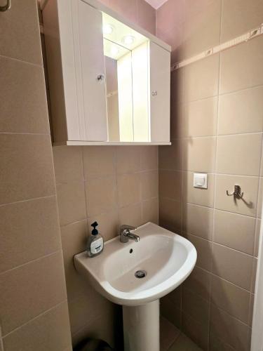 a bathroom with a sink and a mirror at Villa Sea View in Chios