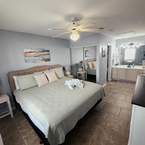a bedroom with a bed with a white animal on it at Condo in Gulf Shores King Suite in Gulf Shores
