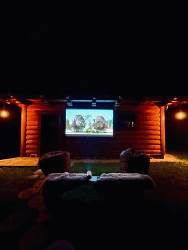 a living room with a tv in the dark at Chata Melissa in Námestovo