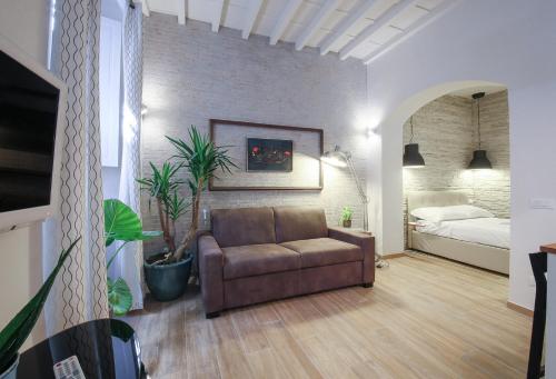 a living room with a couch and a bed at Apartments Florence - Rosa piccolo in Florence