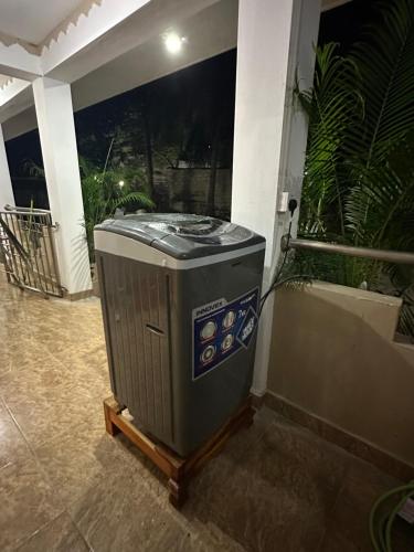 a trash can sitting outside of a building at Meraathanam in Jaffna