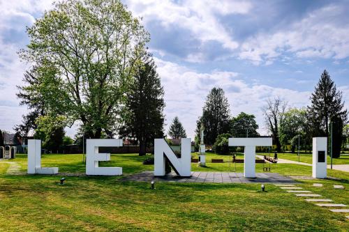 a large sign in the grass in a park at Villa Oliver Lenti in Lenti