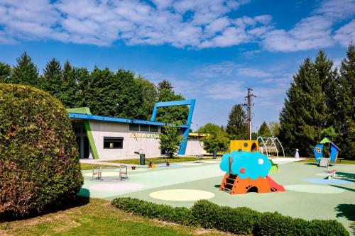 a park with a playground with a slide at Villa Oliver Lenti in Lenti
