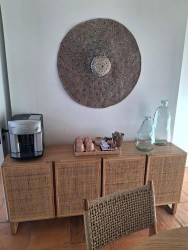 a table with a coffee maker and a mirror on the wall at Umoya Residence in Cape Town