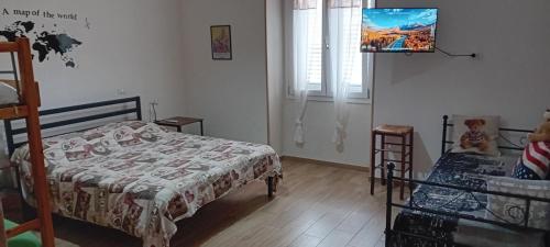 a bedroom with a bed and a tv on the wall at Casa blu in Partanna