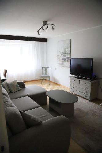 a living room with a couch and a tv at Vabaduse Apartment - külaliskorter Kärdlas in Kärdla