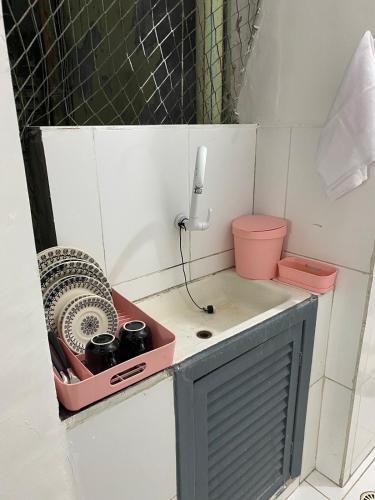 a kitchen with a sink with a phone on it at Kitnet compacta in Salvador