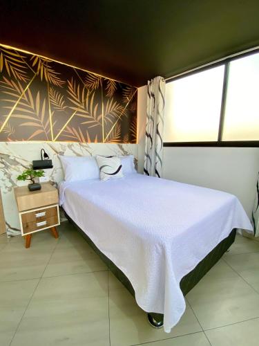 a bedroom with a white bed and a large window at Casa de Bris in Arequipa