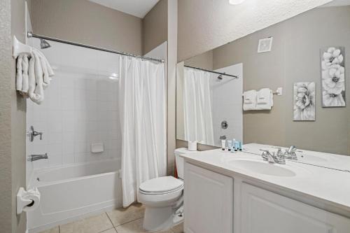 a bathroom with a sink and a toilet and a shower at Orlando Resort Rentals at Universal Boulevard in Orlando