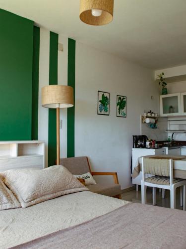 a bedroom with a green and white stripe wall at Dolce Casa Departamentos in Neuquén