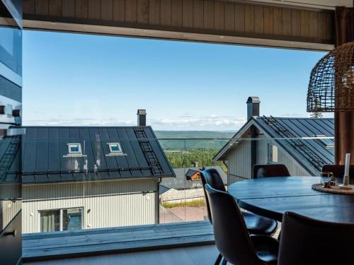 a table and chairs on a balcony with a large window at Lindvallen Ski Resort - Sauna - 10 Guests in Sälen