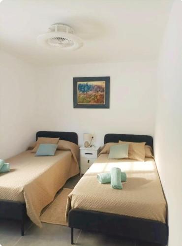 two beds sitting next to each other in a room at Casa Robles, casa con piscina y barbacoa in Partida de La Cañada