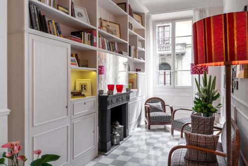 a living room with a fireplace and bookshelves at Alfieri9 in Florence