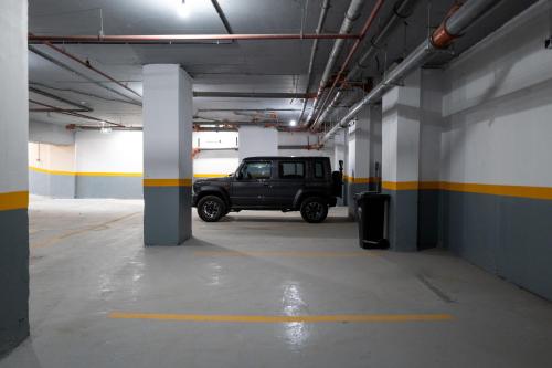 a parking garage with a jeep parked in it at فندق زوايا الماسية الدائري in Al Madinah