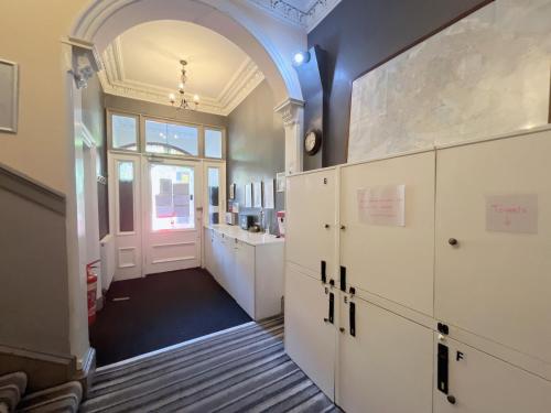 a room with a hallway with white cabinets and a door at Allison House 16 in Edinburgh