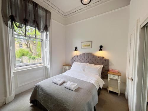 a bedroom with a bed with two towels on it at Allison House 16 in Edinburgh