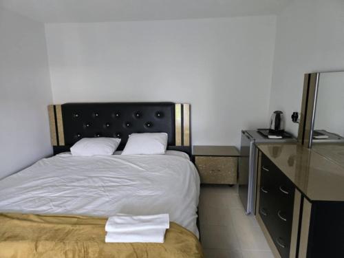 a bedroom with a bed with two white pillows at Villa Toni Mediterranean Family Lake Retreat in Star Dojran
