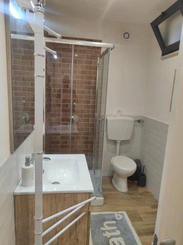 a bathroom with a sink and a shower and a toilet at Casa blu in Partanna