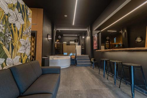 a living room with a couch and a bar at Casa Per Bacco in Vallecrosia