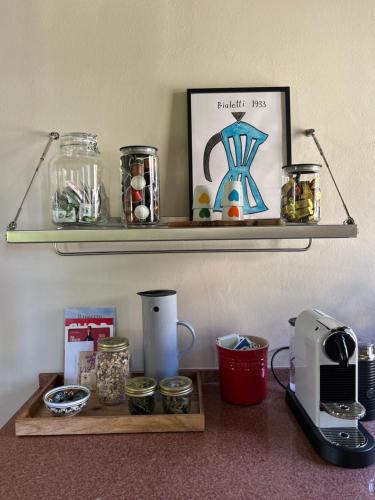 a shelf with jars and a toaster on a counter at Boutique Bio Agriturismo Casale San Cristoforo in Città di Castello