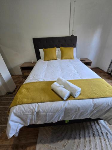 a bedroom with a bed with two towels on it at 55 New Street, Makhanda in Grahamstown