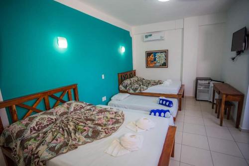 a bedroom with two beds and a blue wall at Hotel Las Palmas en Laurel in Cancún