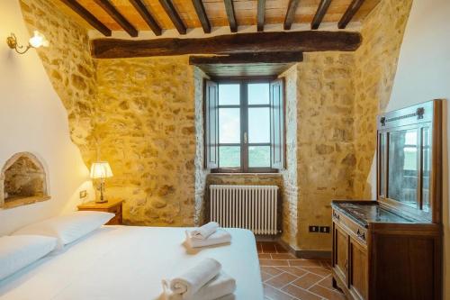 a bedroom with a large bed and a window at Castello di Cisterna in Cisterna