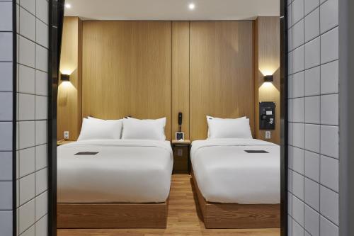 a hotel room with two beds in a corridor at Justsleep hotel Cheonan Dujeong branch in Cheonan
