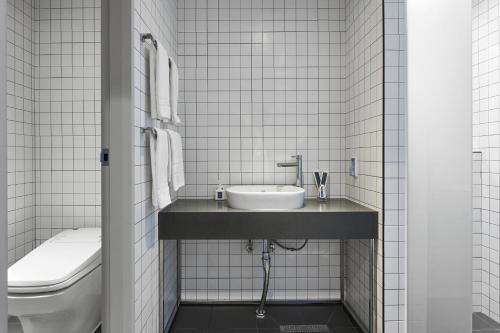 a bathroom with a sink and a toilet at Justsleep hotel Cheonan Dujeong branch in Cheonan