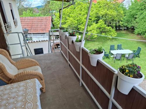 a balcony with potted plants and a table and chairs at Ferienhaus Stani in Eschwege