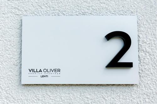 a white card with the number on a wall at Villa Oliver Lenti in Lenti