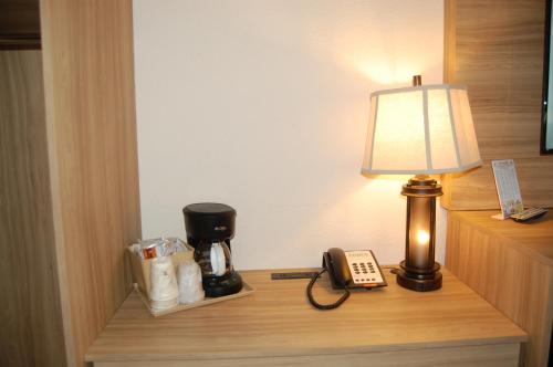 a desk with a lamp and a coffee maker and a phone at Vacation Lodge in Pigeon Forge