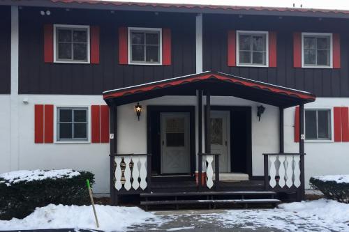 a black and white house with snow in front of it at Glen Land 7 in Bartlett