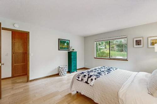 a white bedroom with a bed and a window at Harmony Haven in Groveland