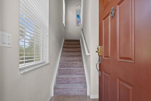 a hallway with a door and a stairway at A hidden Gem in plain sight in Orlando