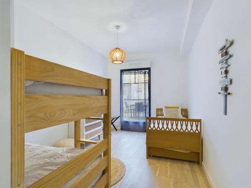 a bedroom with a bunk bed and a crib at 50m de la plage - terrasse - 3 adultes et 3 enfants in Pléneuf-Val-André